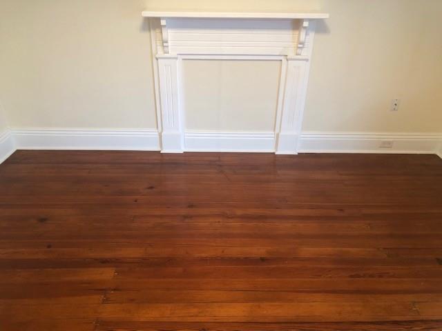 526 Bellecastle St, New Orleans, LA 70115 - empty room featuring dark wood-style floors and baseboards