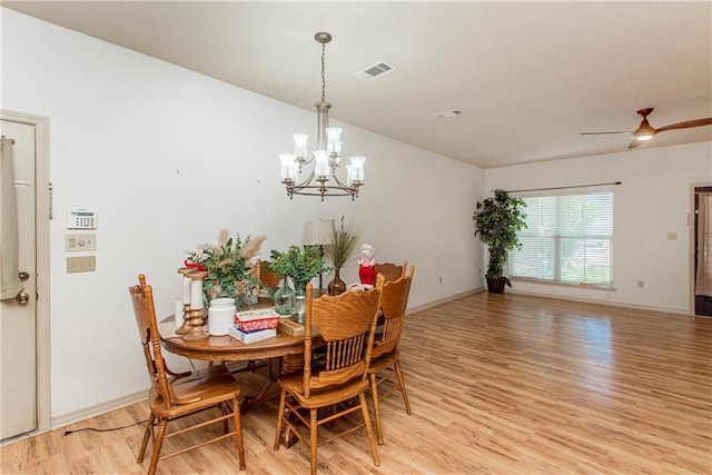 18335 Fox Hollow Loop, Hammond, LA 70401 - dining room featuring baseboards, ceiling fan with notable chandelier, light wood-type flooring, and visible vents