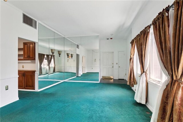 interior space featuring baseboards, dark carpet, and visible vents