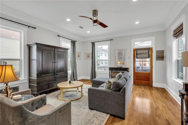 living area with ceiling fan, light wood-style flooring, baseboards, and visible vents