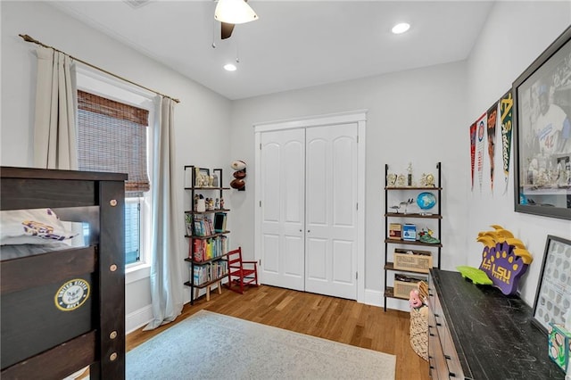 bedroom with a closet, recessed lighting, baseboards, ceiling fan, and wood finished floors