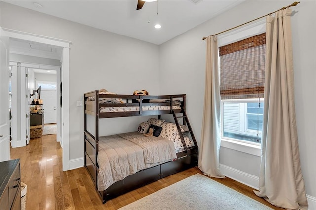 bedroom with baseboards, recessed lighting, light wood-type flooring, and a ceiling fan