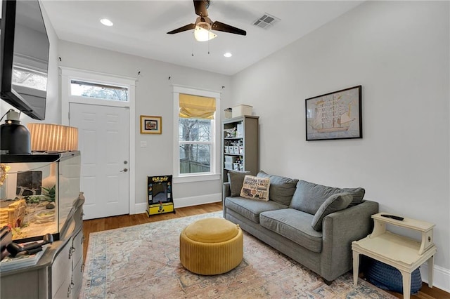 living area featuring wood finished floors, visible vents, recessed lighting, ceiling fan, and baseboards