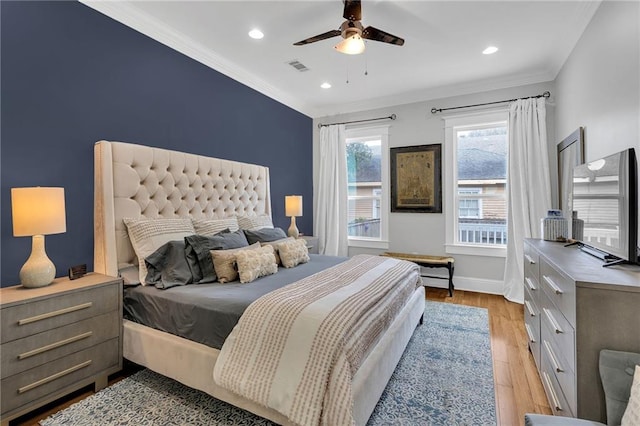 bedroom with a ceiling fan, recessed lighting, visible vents, crown molding, and wood finished floors