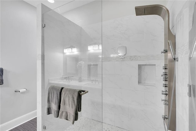 bathroom featuring baseboards and a shower stall