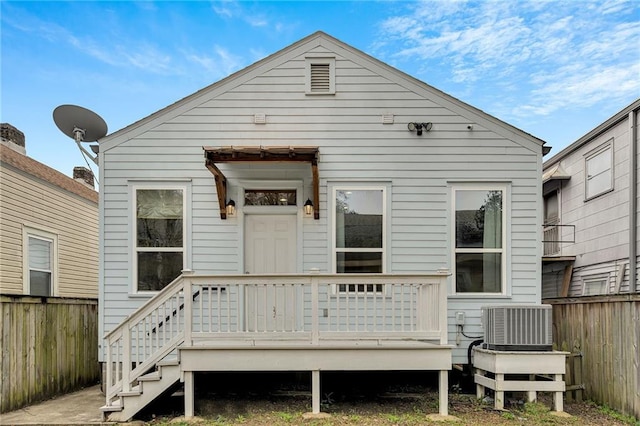 back of property with central air condition unit, fence, and a deck