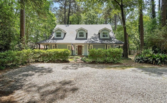 cape cod-style house featuring covered porch