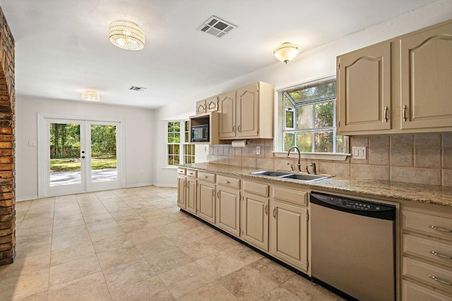 kitchen featuring dishwasher, baseboards, visible vents, a sink, and tasteful backsplash