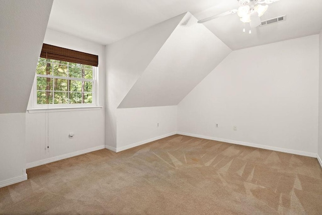 bonus room featuring lofted ceiling, carpet, visible vents, a ceiling fan, and baseboards