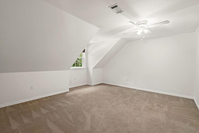 additional living space with visible vents, baseboards, ceiling fan, and carpet floors