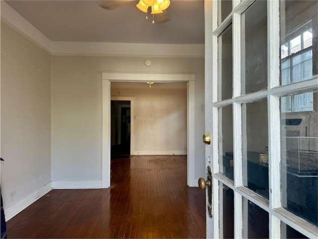 empty room with hardwood / wood-style floors, baseboards, and a ceiling fan