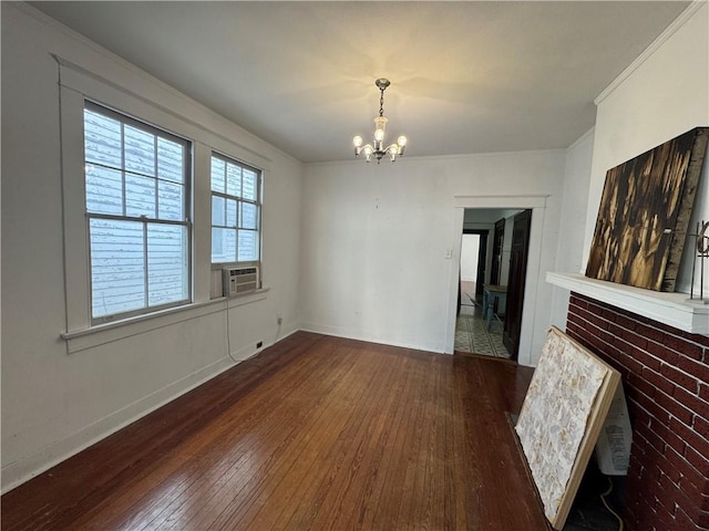 unfurnished dining area with a chandelier, hardwood / wood-style floors, baseboards, cooling unit, and crown molding