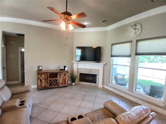 living room with crown molding, light tile patterned floors, and a wealth of natural light
