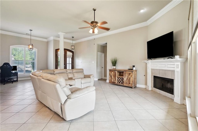 217 Turning Leaf Ln, Madisonville, LA 70447 - living room featuring light tile patterned floors, a ceiling fan, ornamental molding, and a tile fireplace