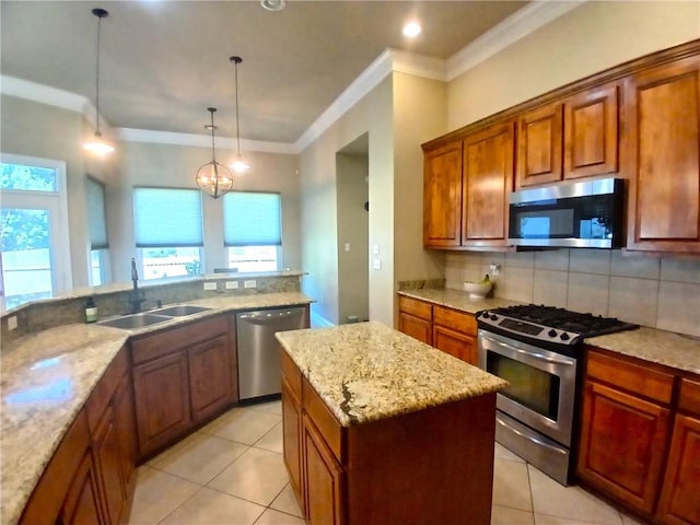 kitchen featuring a sink, tasteful backsplash, a kitchen island, and appliances with stainless steel finishes