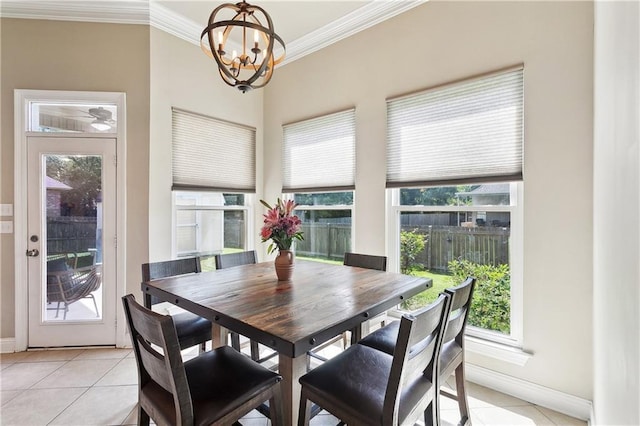 217 Turning Leaf Ln, Madisonville, LA 70447 - dining space featuring light tile patterned floors, ornamental molding, a chandelier, and baseboards