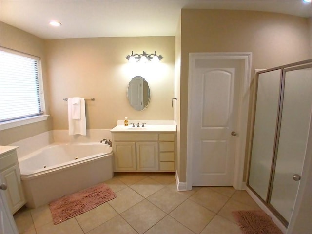 bathroom with a stall shower, tile patterned flooring, vanity, and a jetted tub