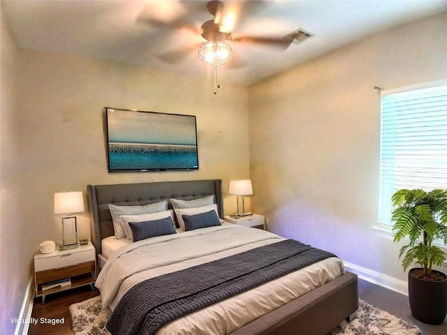 217 Turning Leaf Ln, Madisonville, LA 70447 - bedroom featuring baseboards, multiple windows, wood finished floors, and a ceiling fan