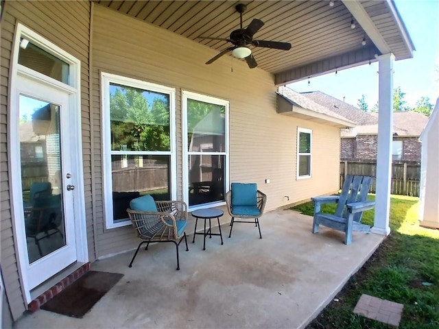 view of patio featuring fence and a ceiling fan