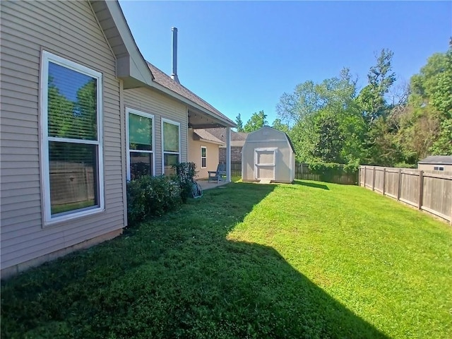 view of yard featuring an outbuilding, a fenced backyard, and a shed