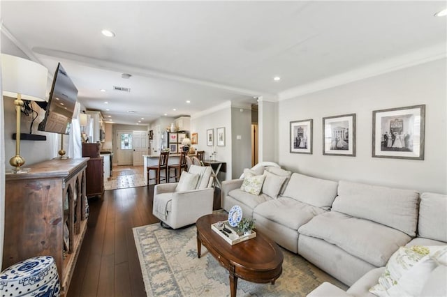 living area featuring recessed lighting, visible vents, crown molding, and dark wood-type flooring