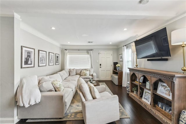 living area with dark wood-style flooring, ornamental molding, and plenty of natural light
