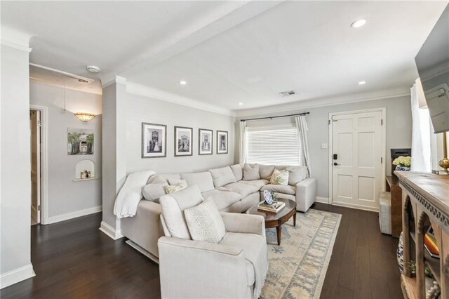 living area with recessed lighting, dark wood finished floors, crown molding, and visible vents