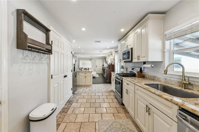 26 Davis Blvd, Jefferson, LA 70121 - kitchen featuring stainless steel appliances, recessed lighting, light stone countertops, and light stone finish flooring
