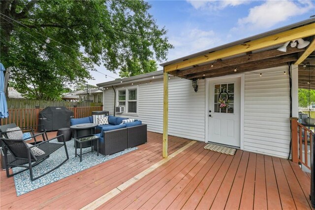 wooden terrace with area for grilling, fence, an outdoor living space, and cooling unit