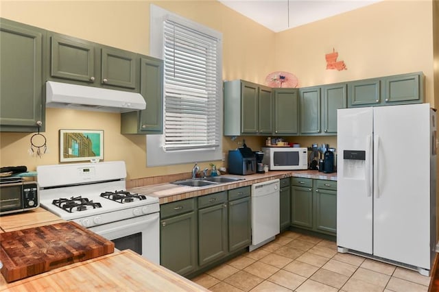 41719 S Genois St, New Orleans, LA 70119 - kitchen featuring light tile patterned floors, a sink, green cabinets, white appliances, and under cabinet range hood