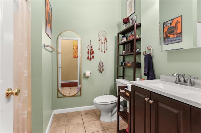 41719 S Genois St, New Orleans, LA 70119 - bathroom featuring tile patterned floors, toilet, baseboards, and vanity