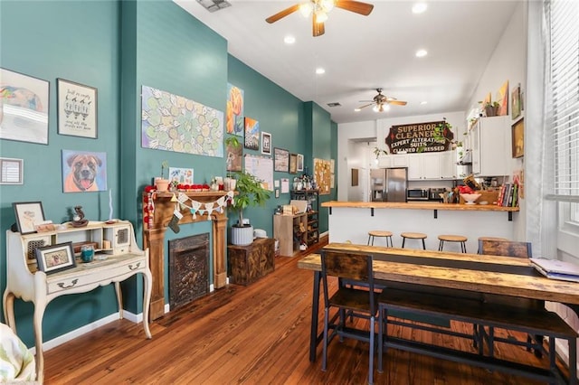 41719 S Genois St, New Orleans, LA 70119 - dining space featuring a fireplace, wood-type flooring, a ceiling fan, and recessed lighting