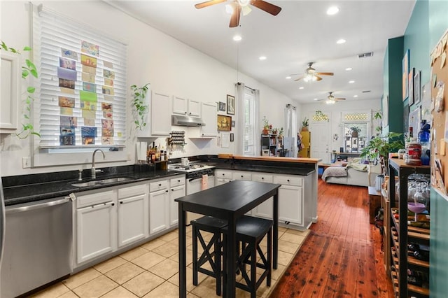 41719 S Genois St, New Orleans, LA 70119 - kitchen featuring range, dishwasher, ceiling fan, a sink, and a peninsula