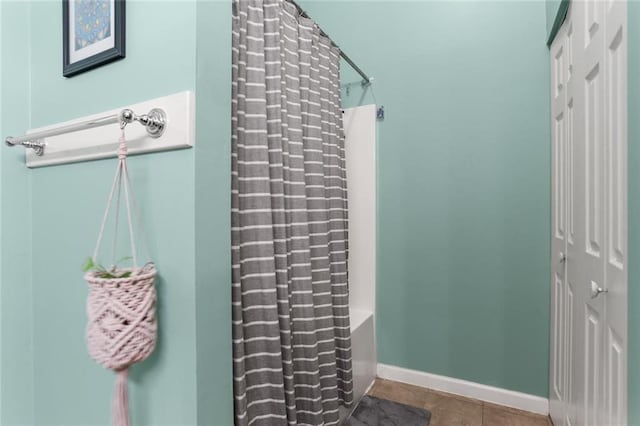 41719 S Genois St, New Orleans, LA 70119 - full bathroom with baseboards, tile patterned flooring, and a shower with shower curtain