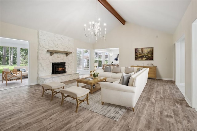 68 Begonia Dr, Covington, LA 70433 - living room featuring beamed ceiling, a notable chandelier, plenty of natural light, and wood finished floors