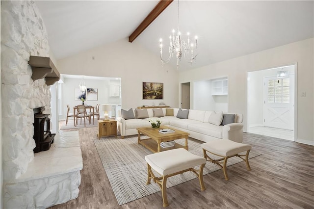 68 Begonia Dr, Covington, LA 70433 - living area with wood finished floors, high vaulted ceiling, baseboards, beamed ceiling, and a chandelier