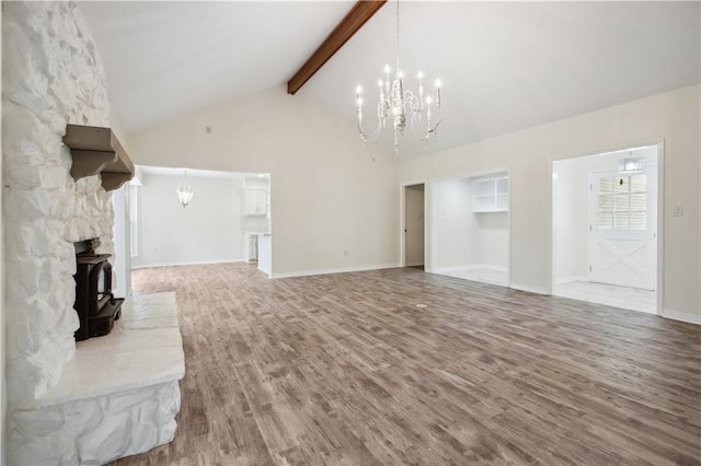 68 Begonia Dr, Covington, LA 70433 - unfurnished living room with a notable chandelier, baseboards, high vaulted ceiling, wood finished floors, and beamed ceiling