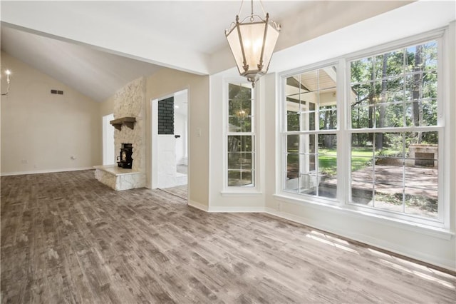68 Begonia Dr, Covington, LA 70433 - unfurnished living room featuring a chandelier, visible vents, plenty of natural light, and wood finished floors