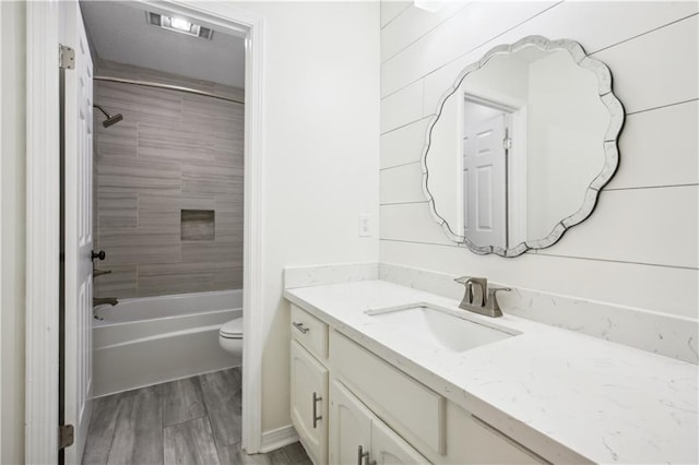 68 Begonia Dr, Covington, LA 70433 - full bathroom with toilet, wood finished floors, vanity, and shower / washtub combination