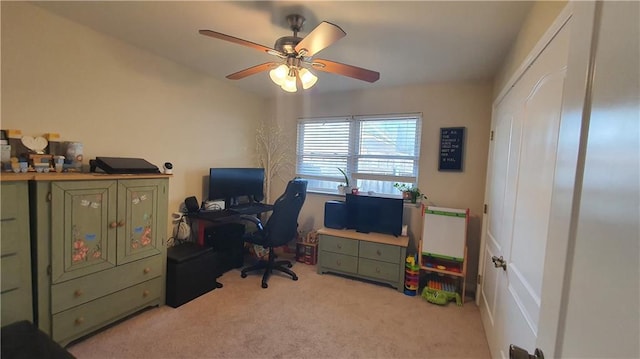 home office featuring light carpet and ceiling fan