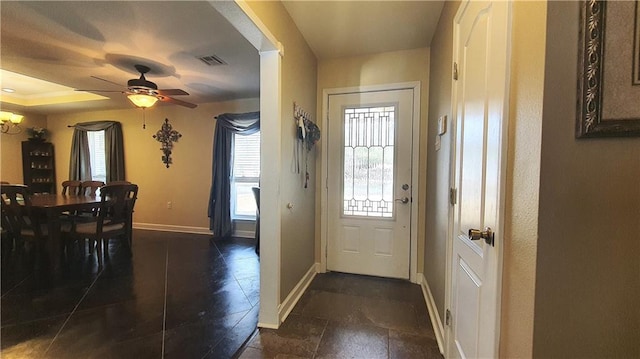 entrance foyer with a ceiling fan and baseboards