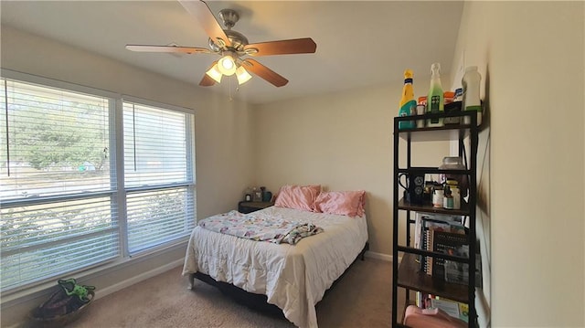 bedroom with baseboards, multiple windows, and carpet
