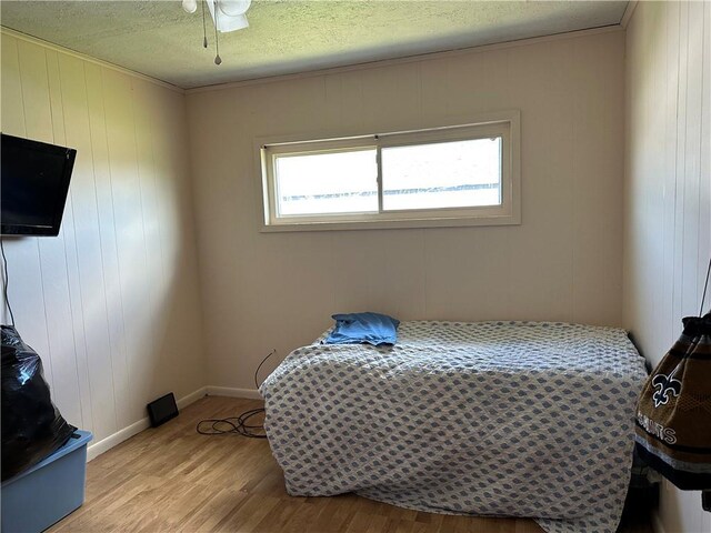 3024 Kansas St, New Orleans, LA 70114 - bedroom with baseboards, light wood-style floors, and a textured ceiling