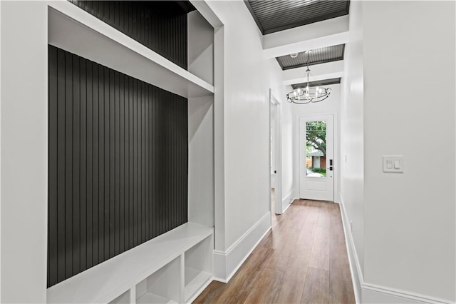 2904 Green Acres Rd, Metairie, LA 70003 - hallway with wood finished floors, a chandelier, and baseboards