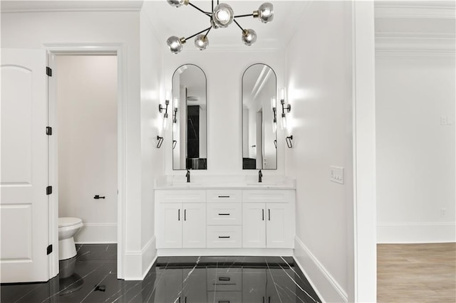 bathroom with baseboards, toilet, and a sink