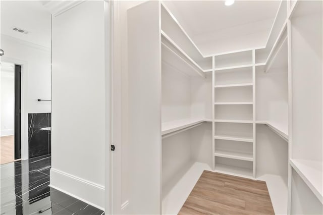 spacious closet with visible vents and wood finished floors