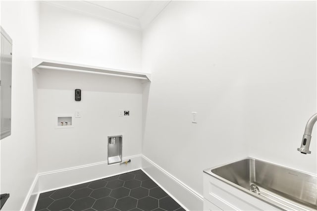 laundry area with dark tile patterned floors, a sink, hookup for a washing machine, hookup for a gas dryer, and baseboards
