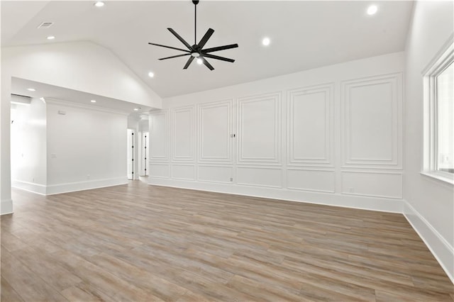 unfurnished living room with ceiling fan, lofted ceiling, light wood-type flooring, and recessed lighting