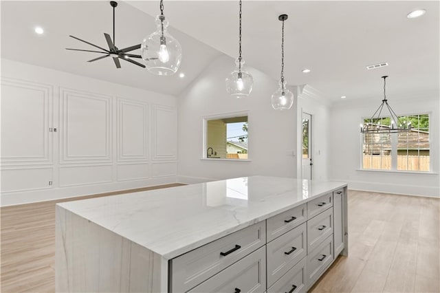 kitchen featuring light wood finished floors, a center island, visible vents, and recessed lighting
