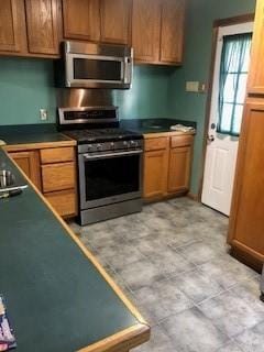 362 W Ave, Harahan, LA 70123 - kitchen with dark countertops, stainless steel appliances, and brown cabinetry